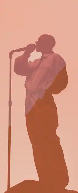 a rapper standing on a huge stage rapping into the microphone