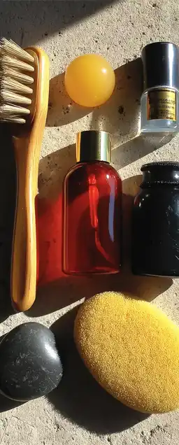 Flat lay of minimal skincare products on a light stone surface, soft shadows and diffused natural light highlighting smooth textures and clean design