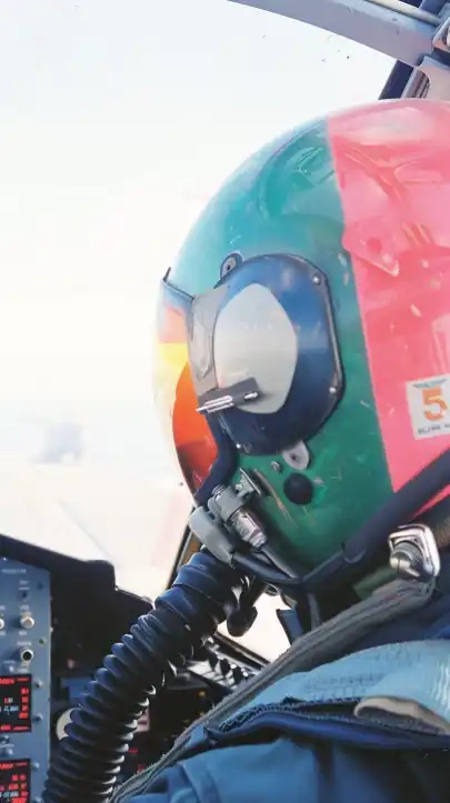 a fighter jet pilot wearing his helmet